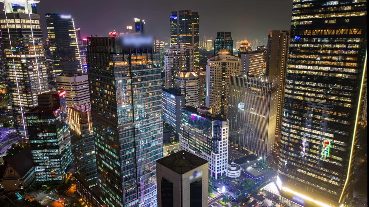City skyline at night with traffic
